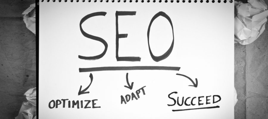 White Paper with the words SEO, Optimize, Adapt, Succeed