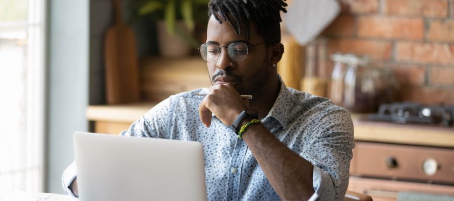 Black Man Reviewing His Business' Search Results Rankings