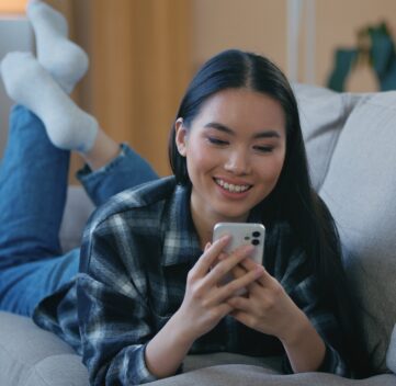 female on a couch watching facebook reels