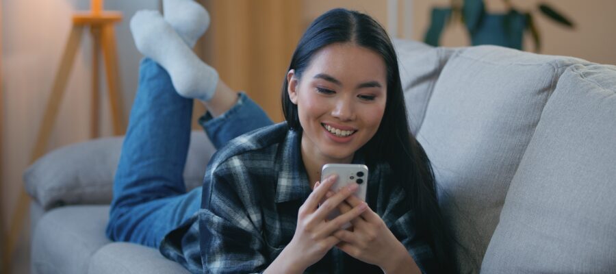 female on a couch watching facebook reels