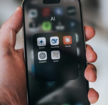 person holding phone looking at AI tools to use to search up information